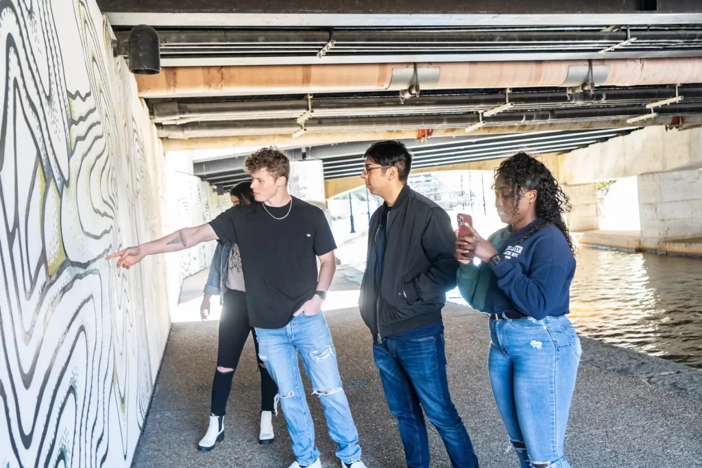 A group looking at a mural