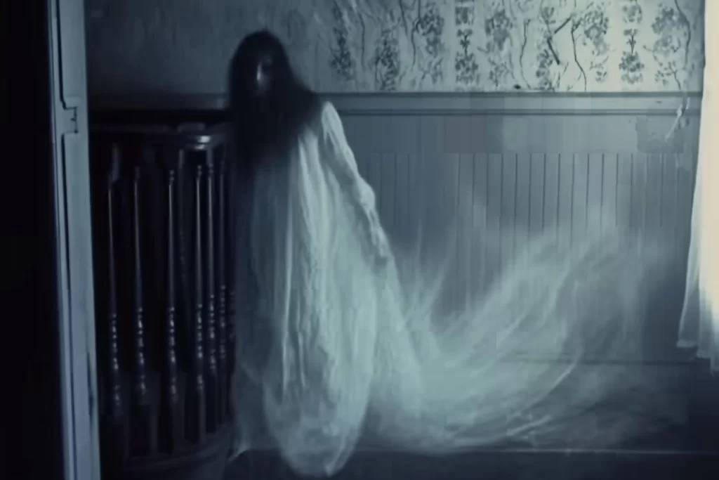 A ghostly woman at the top of a staircase