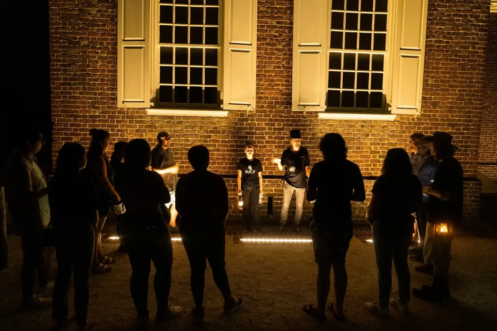 Tour guide spinning chilling ghost tales for guests