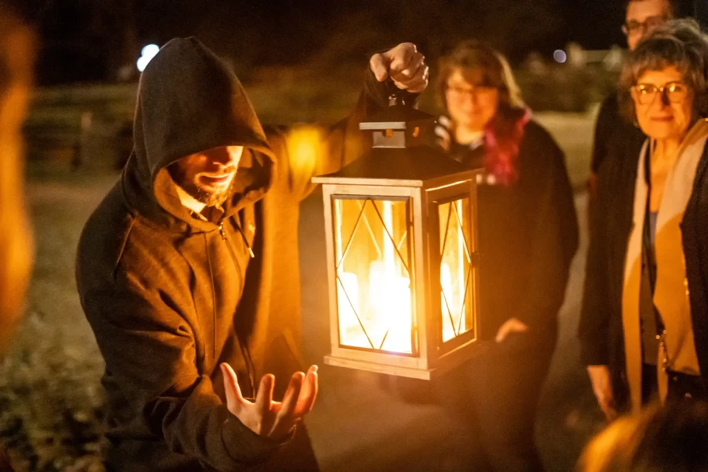 Tour guide holding a lantern